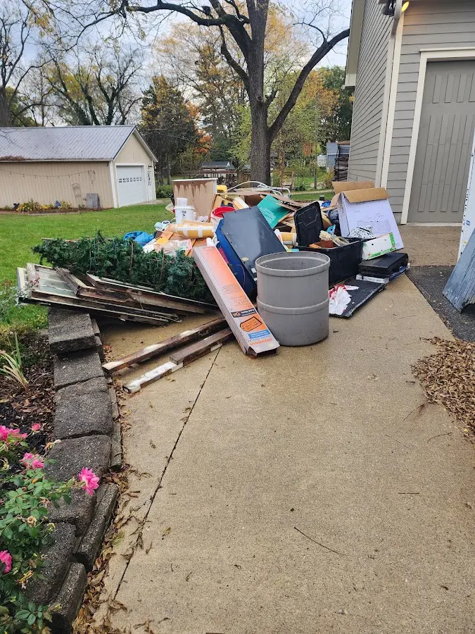 Dumpster being loaded with debris for 3 Yard Dumpster Rental in Cross Plains